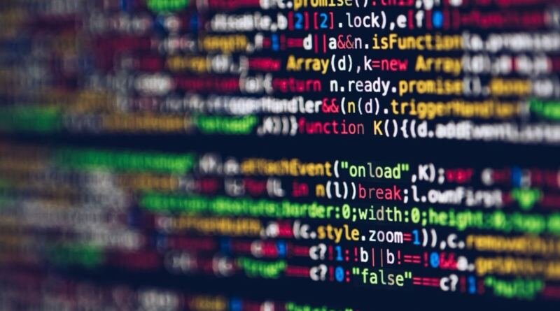 Blurred lines of colourful code on a dark monitor, illustrating the Ghost AI Core personal AI computer