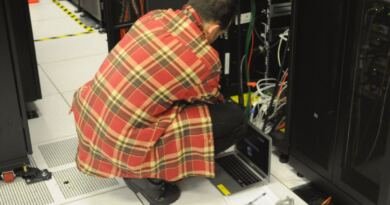 Technician working on a data center server rack, illustrating Microsoft Maia 300 rack-scale deployments