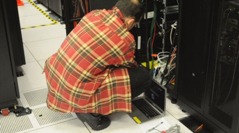 Technician working on a data center server rack, illustrating Microsoft Maia 300 rack-scale deployments