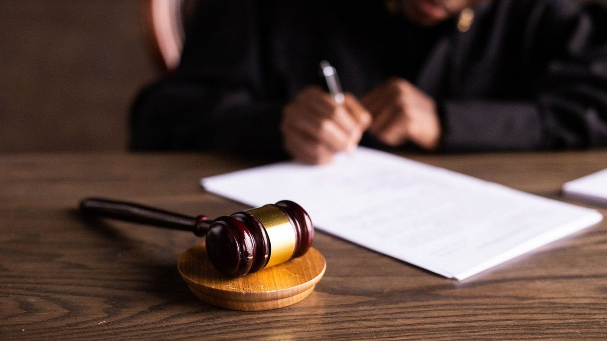 Gavel and signed court papers on a wooden bench, illustrating the Character.AI bankruptcy