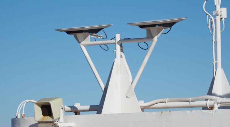 Two flat Starlink satellite dishes on a white mast against a blue sky, illustrating the stalled Starlink India launch