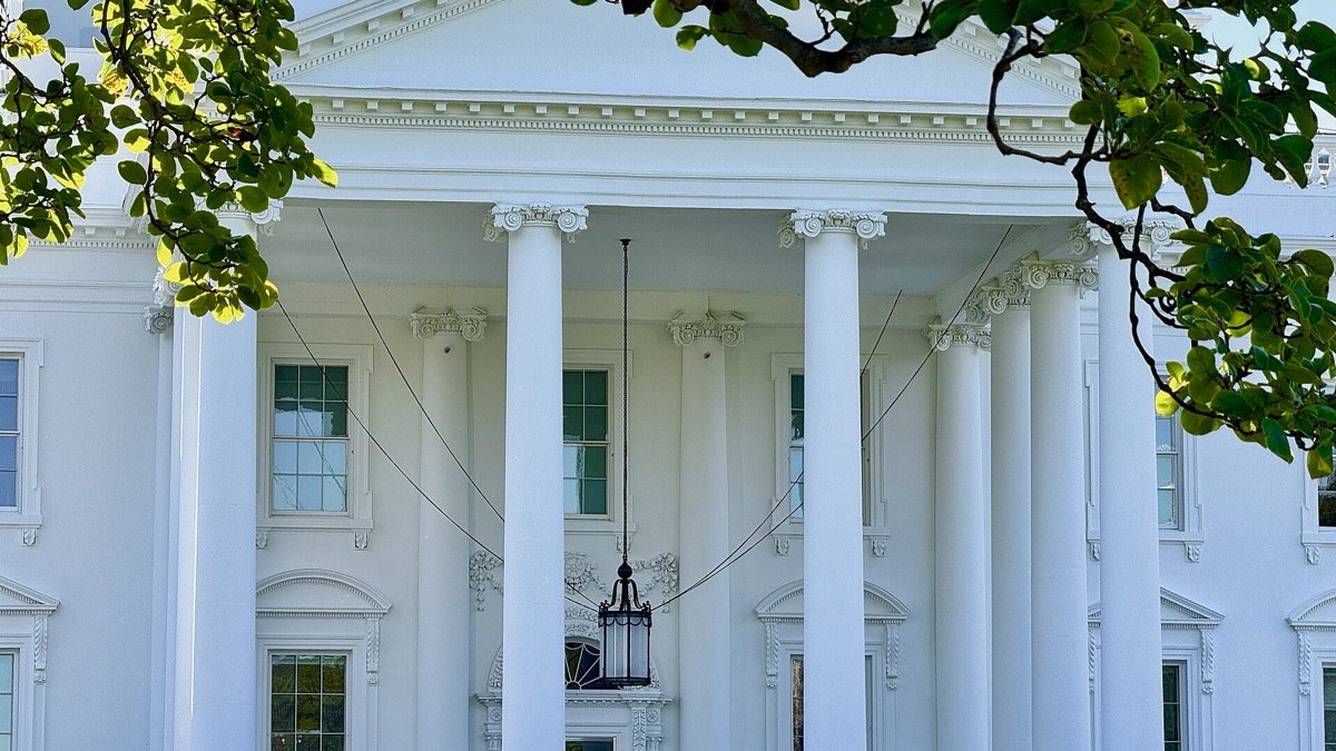The North Portico of the White House seen through a magnolia branch, illustrating the Super Intelligence executive order